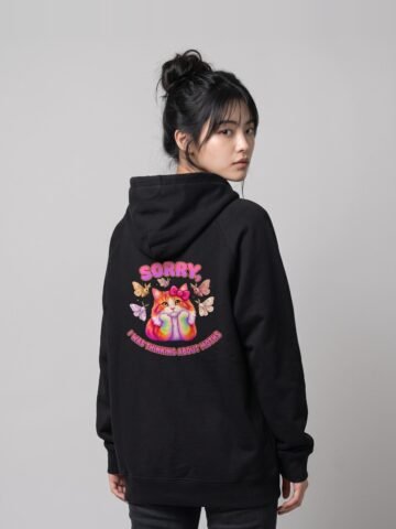 Back view of a woman wearing the black Distracted Puddy Tat raglan hoodie by Keanu Organics