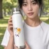 Keanu's Breathwork Bottle in white held by model in the park