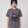 Woman wearing the anthracite Mahavatar Keanu Ultra Garment-Dyed Tee — Keanu in purple shades, paws together under a mandala halo