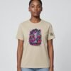 Woman wearing the Desert Dust Mushroom Guardian organic cotton tee, front view