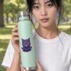 Mycelial Mind Copper Bottle in mint held by model in the park