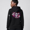 Woman wearing the black Neon Heartbreak midweight hoodie with the neon heart design and white sleeve logo