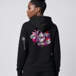 Woman wearing the black Neon Heartbreak midweight hoodie with the neon heart design and white sleeve logo