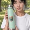 Prism Copper Bottle in mint held by model in the park