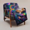 Puddynaut Throw Blanket draped over an armchair